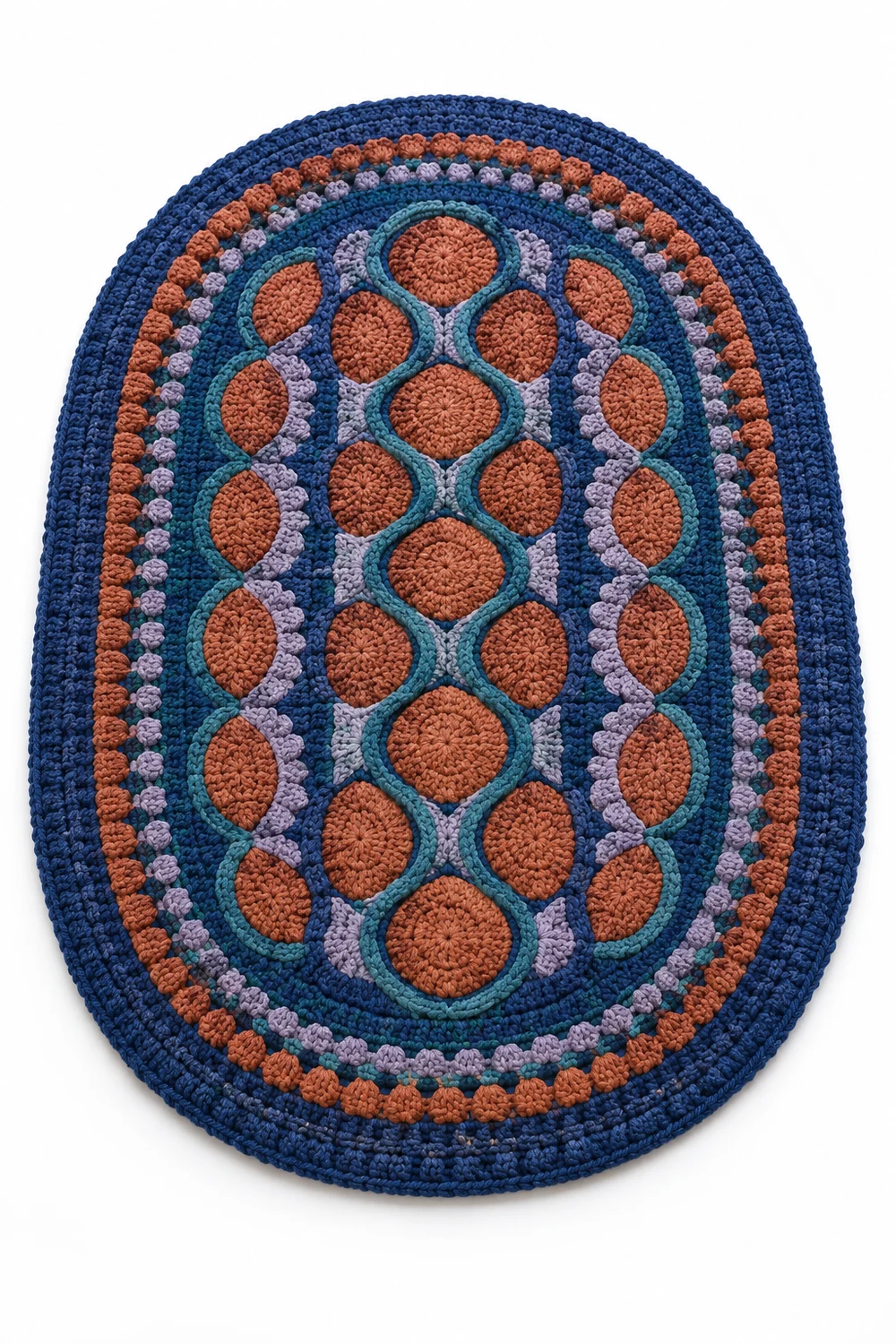 Cobalt blue oval crochet rug with cobblestone mosaic and raised border