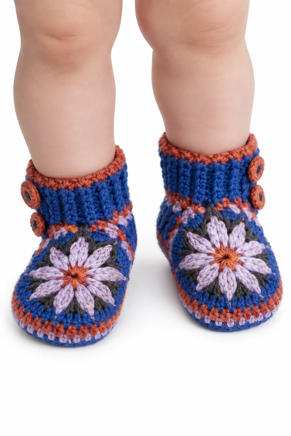 Cobalt blue crochet baby booties with side buttons and petal pattern