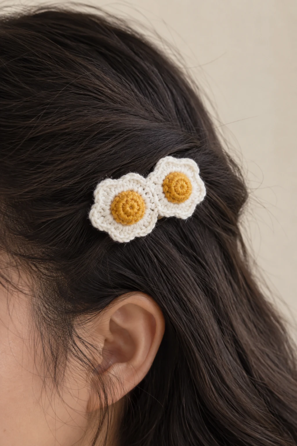 Crochet hair clip with two fried egg motifs