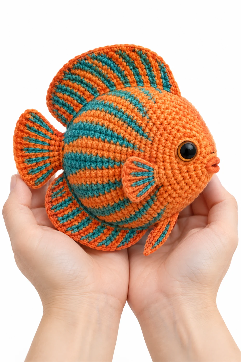 Orange crochet discus fish amigurumi with round body