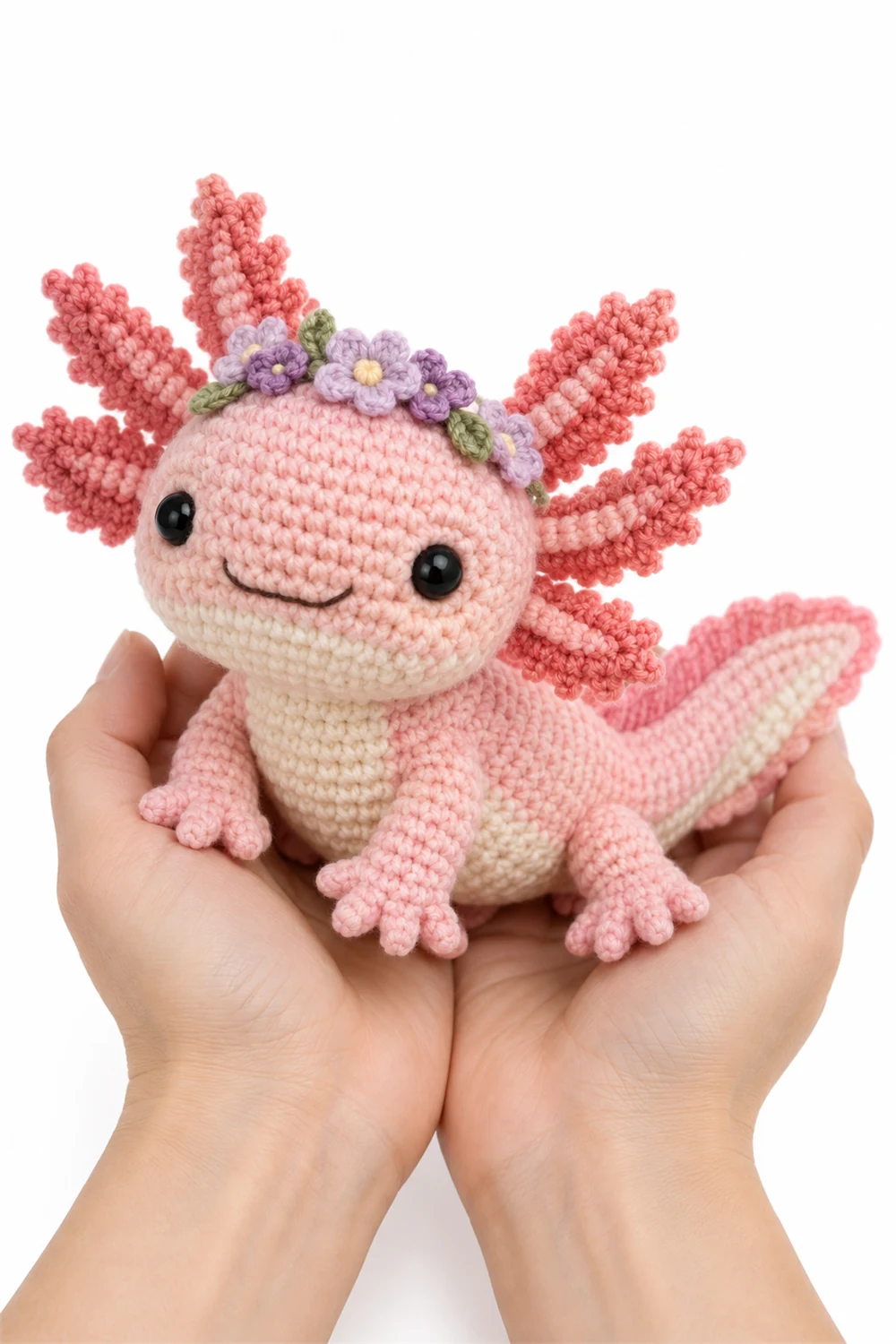 Rose pink crochet axolotl amigurumi with flower-like gills