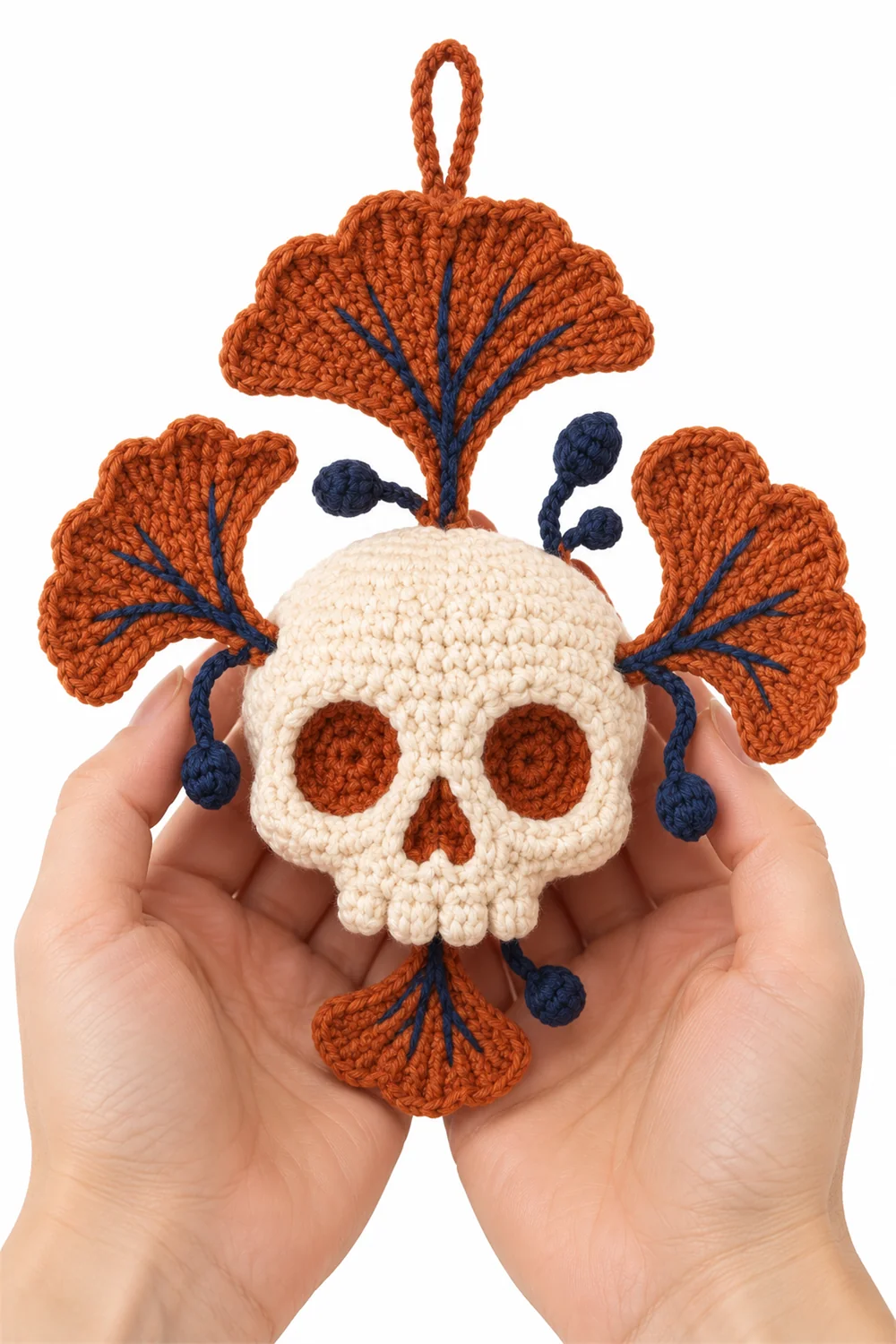 Rust orange crochet skull charm with ginkgo leaf fan shape