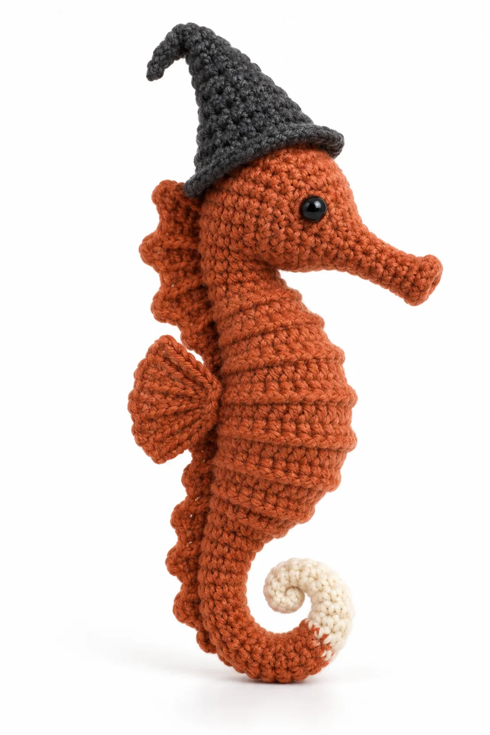 Rust orange crochet seahorse with tiny witch hat