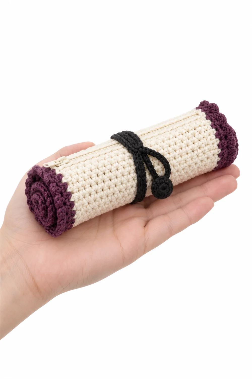 Crochet pouch shaped like a rolled spell scroll